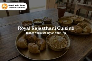Traditional Royal Rajasthani cuisine with authentic dishes served on brass plates during a Rajasthan trip by Shakti India Tours
